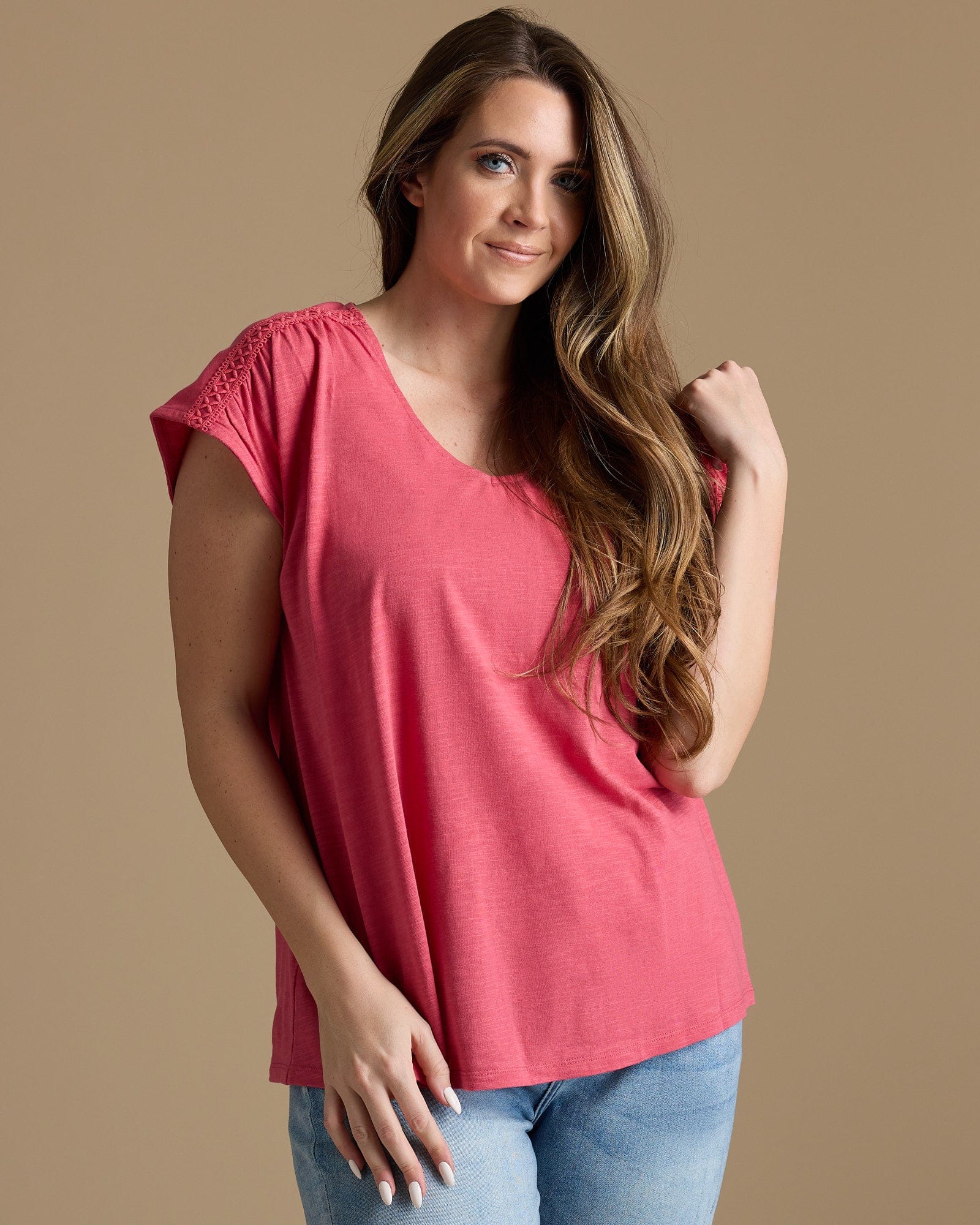 Woman in a pink v-neck top