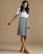 Woman in black and white striped knee-length skirt