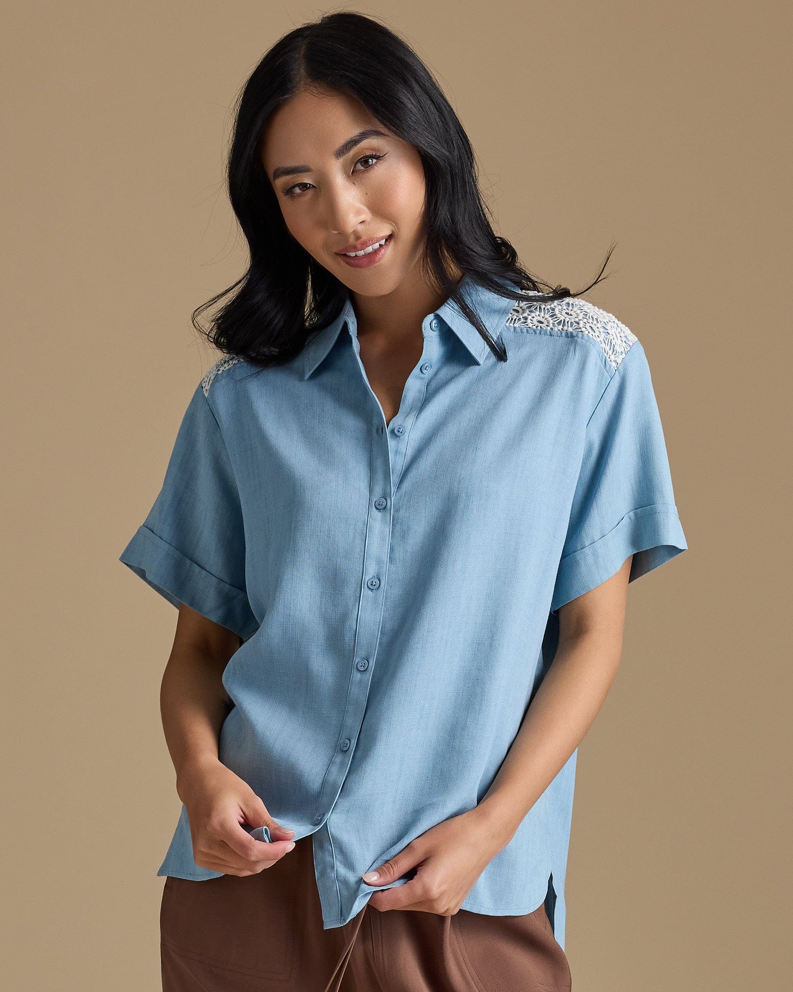 Woman in a light blue chambray button-down