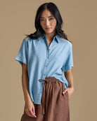 Woman in a light blue chambray button-down
