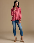 Woman in a pink long sleeve blouse