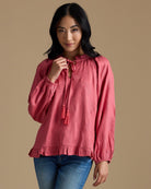 Woman in a pink long sleeve blouse