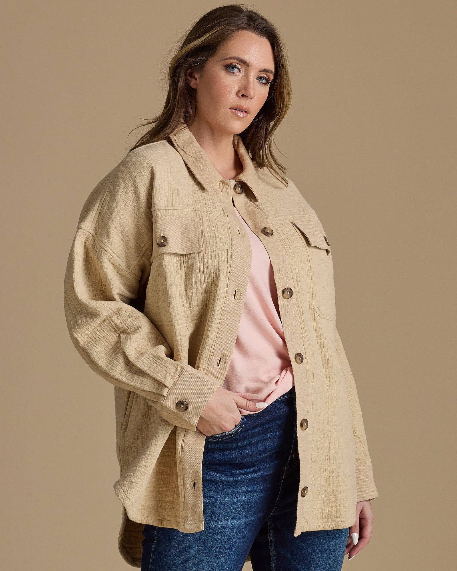 Woman in tan long sleeved textured jacket