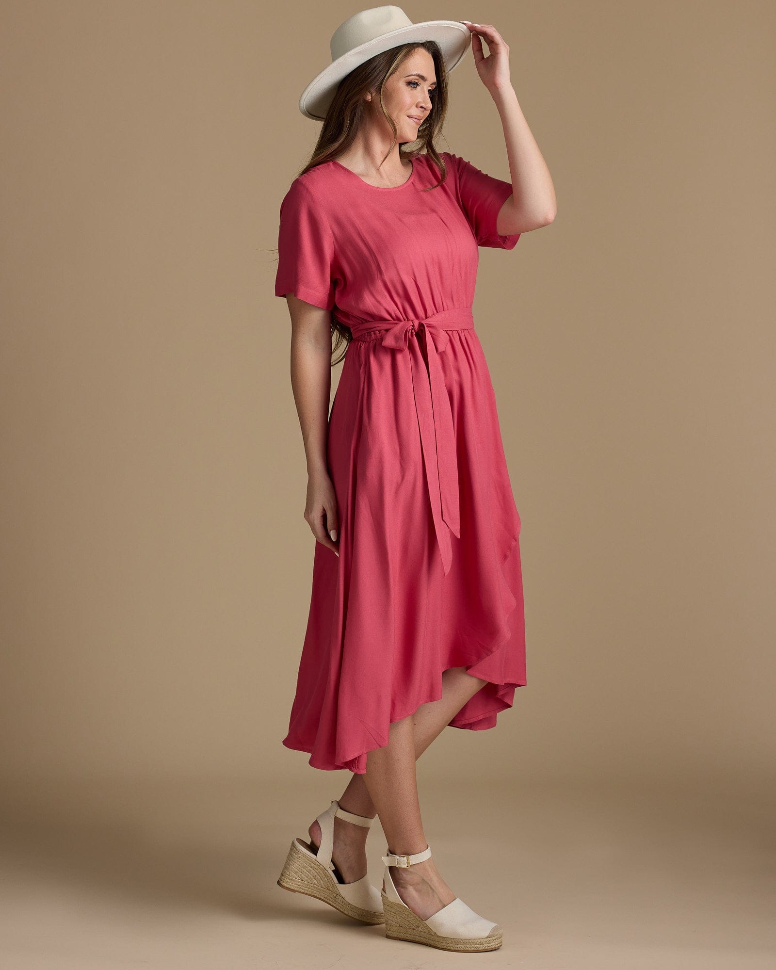 Woman in a short sleeve, wrap skirt, pink dress