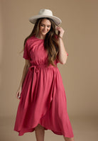 Woman in a short sleeve, wrap skirt, pink dress