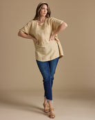 Woman in an oversized, peplum blouse