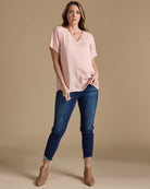 Woman in a pink blouse with short sleeves