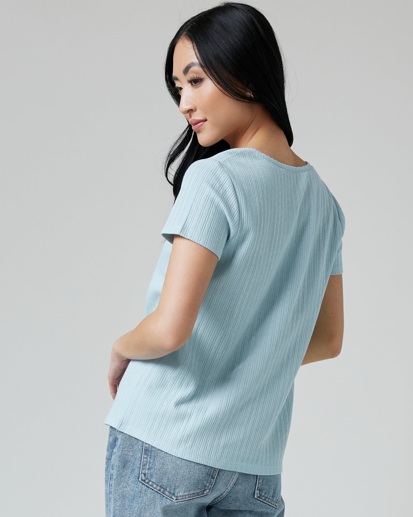 Woman in a blue short sleeved v-neck tee
