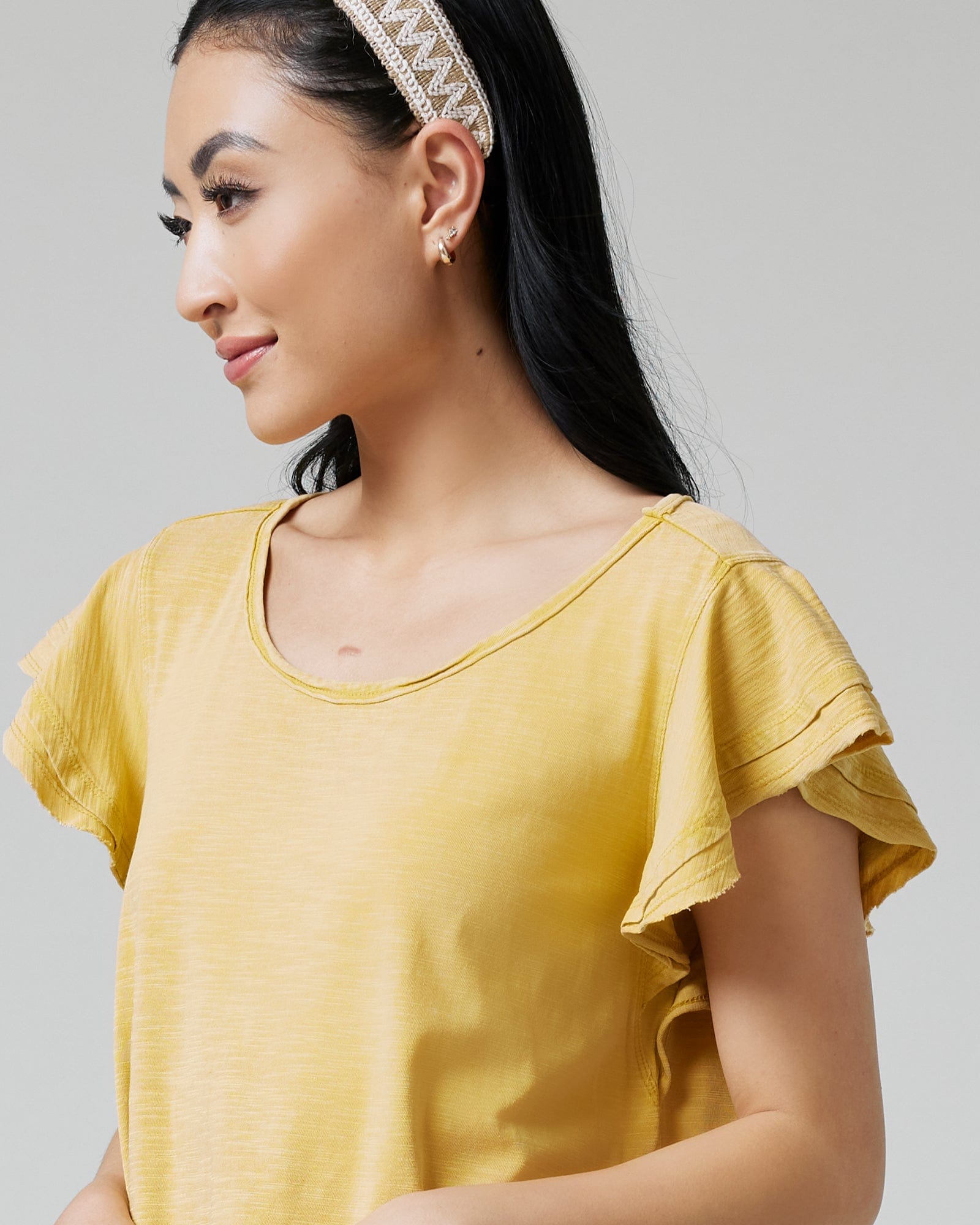 Woman in a top with short, flutter sleeves