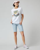 Woman in a white graphic tee with "Venice Beach" on front