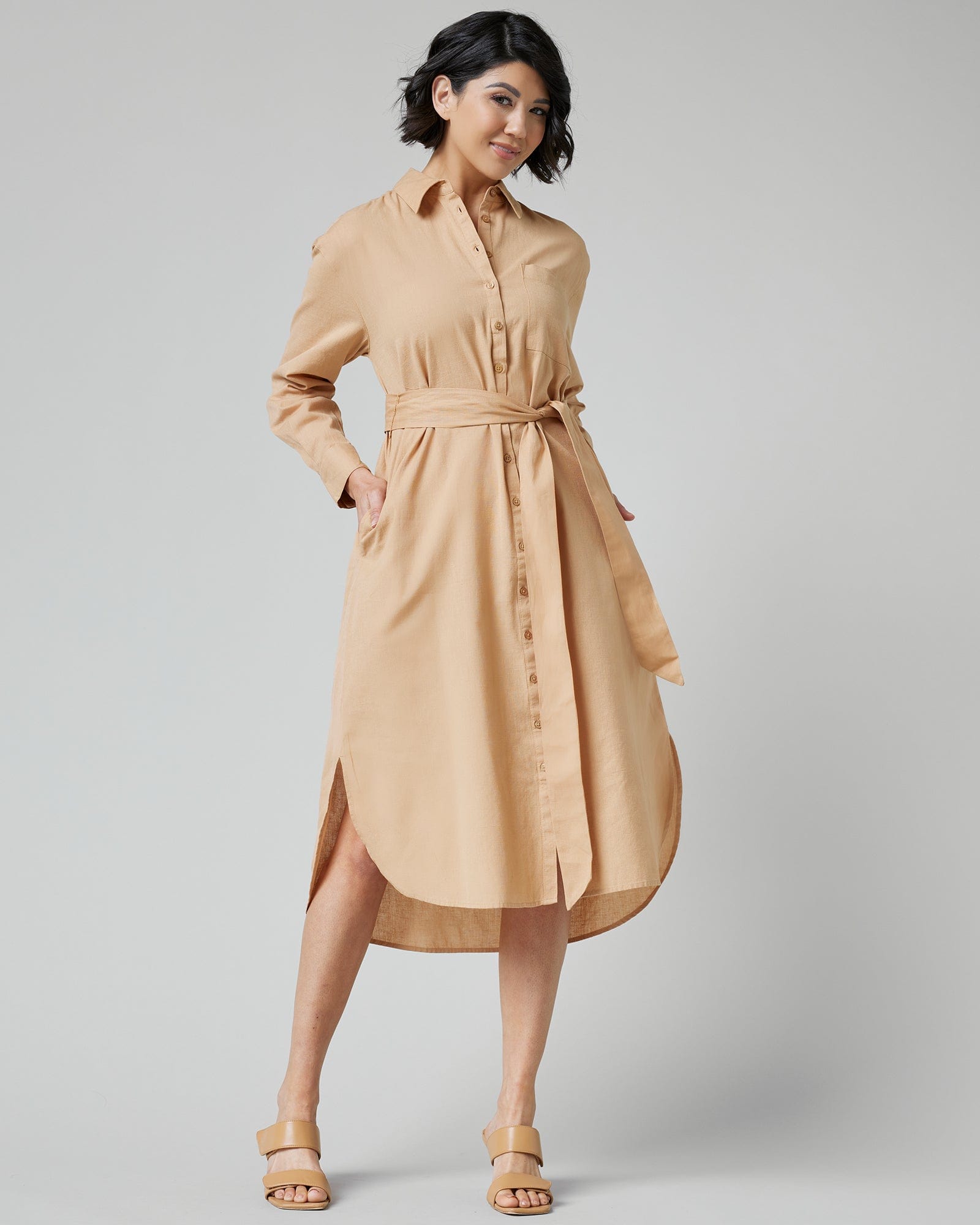 Woman in a long sleeve, knee-length, collared, button-down dress