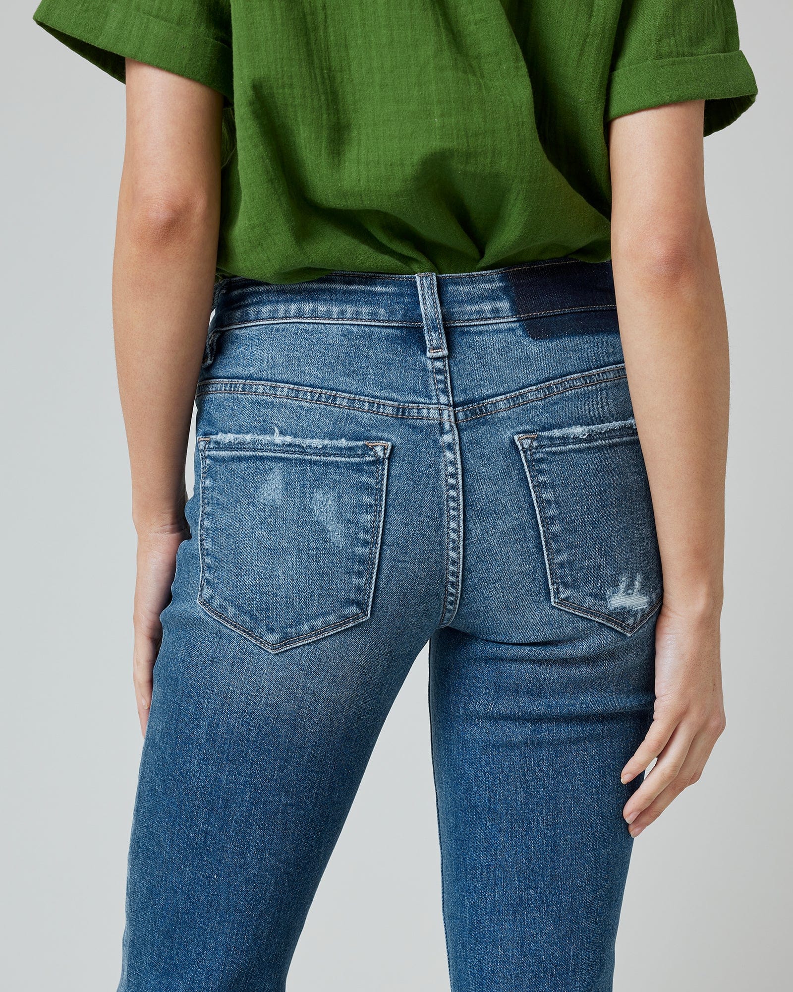 Woman in blue mid-rise cropped denim pants