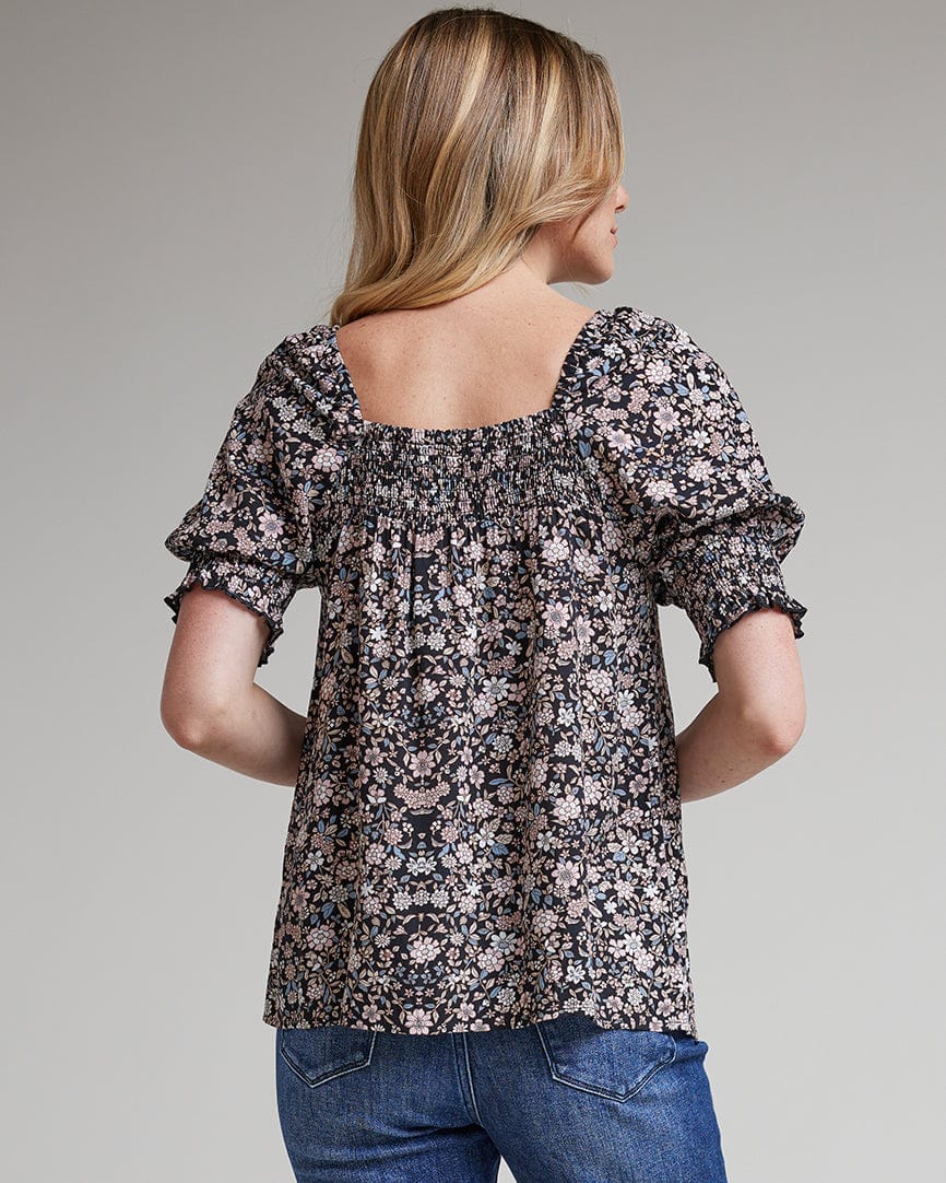 Woman in a floral printed, off the shoulder, short sleeve blouse