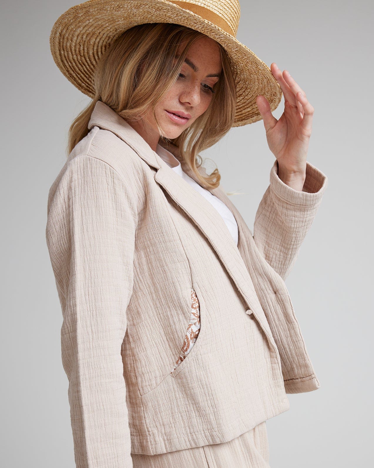 Woman in tan long sleeve textured blazer