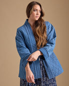 Woman in blue long sleeve quilted jacket