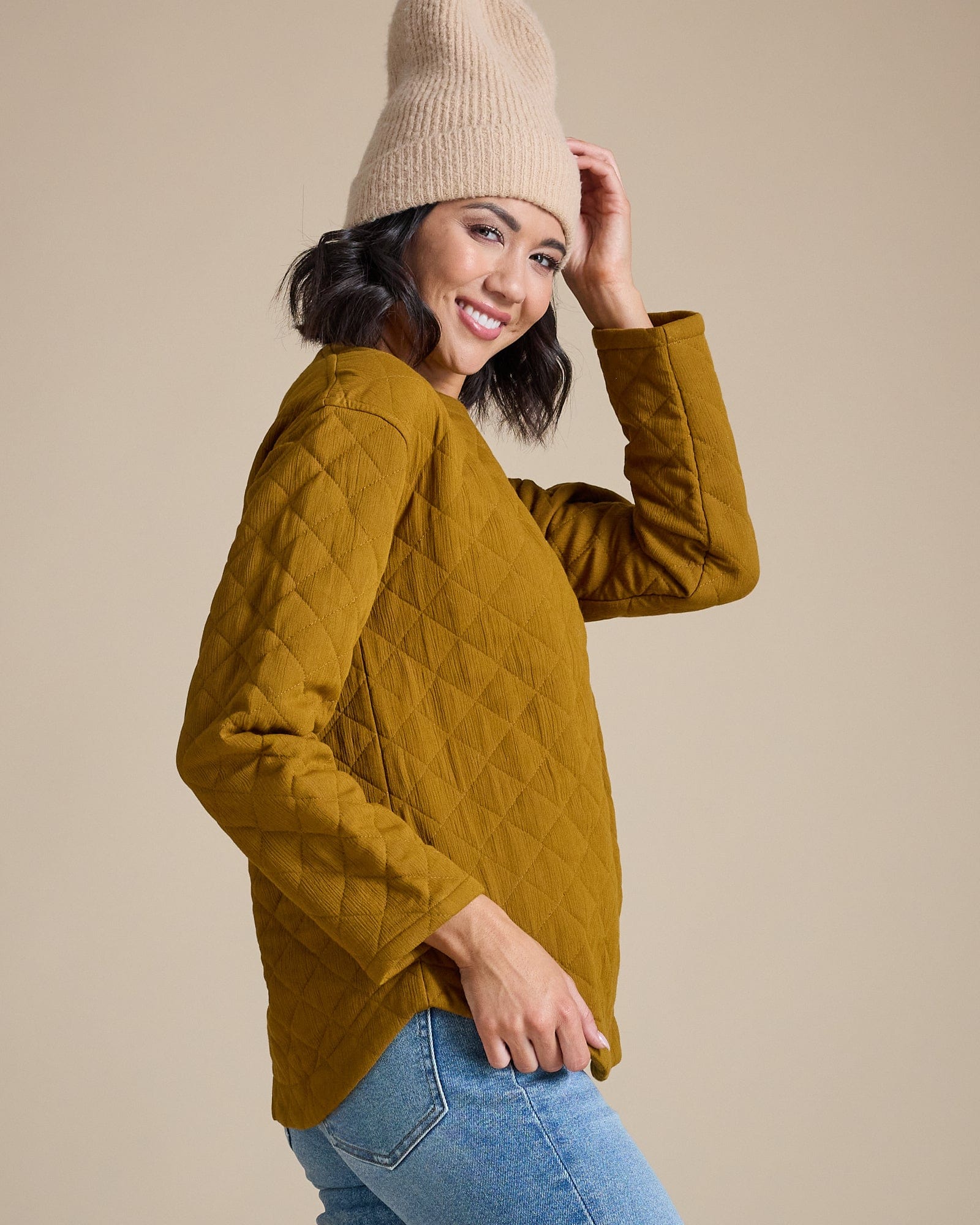 Woman in a green long sleeve quilted top