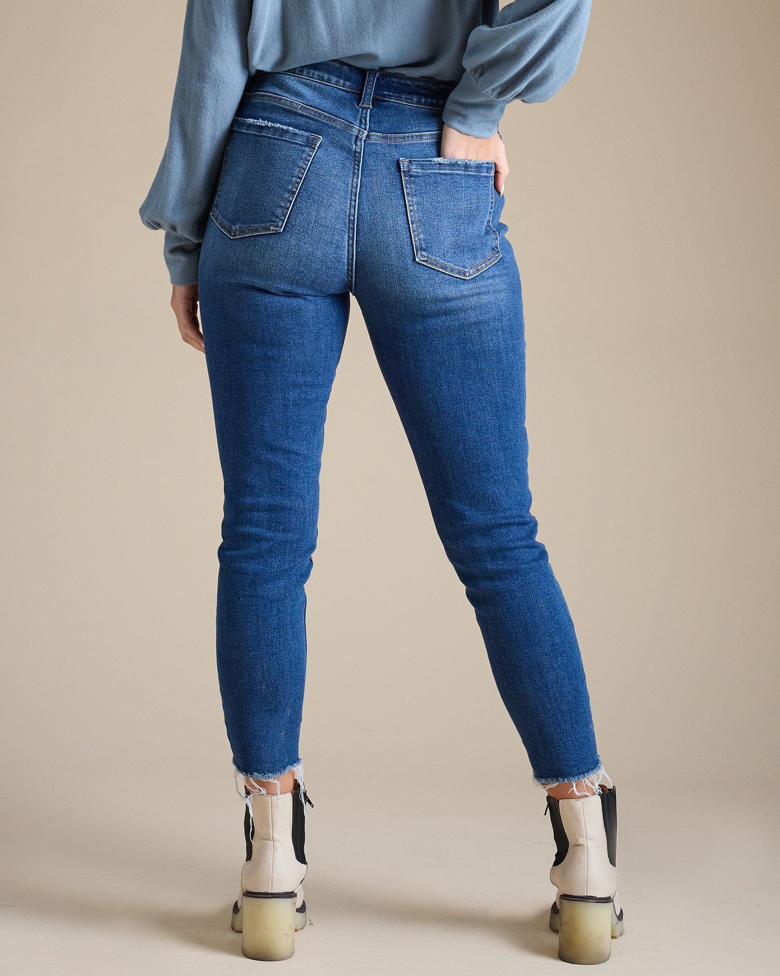 Woman in blue mid-rise skinny jeans