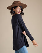 Woman in a black long sleeve flowy top